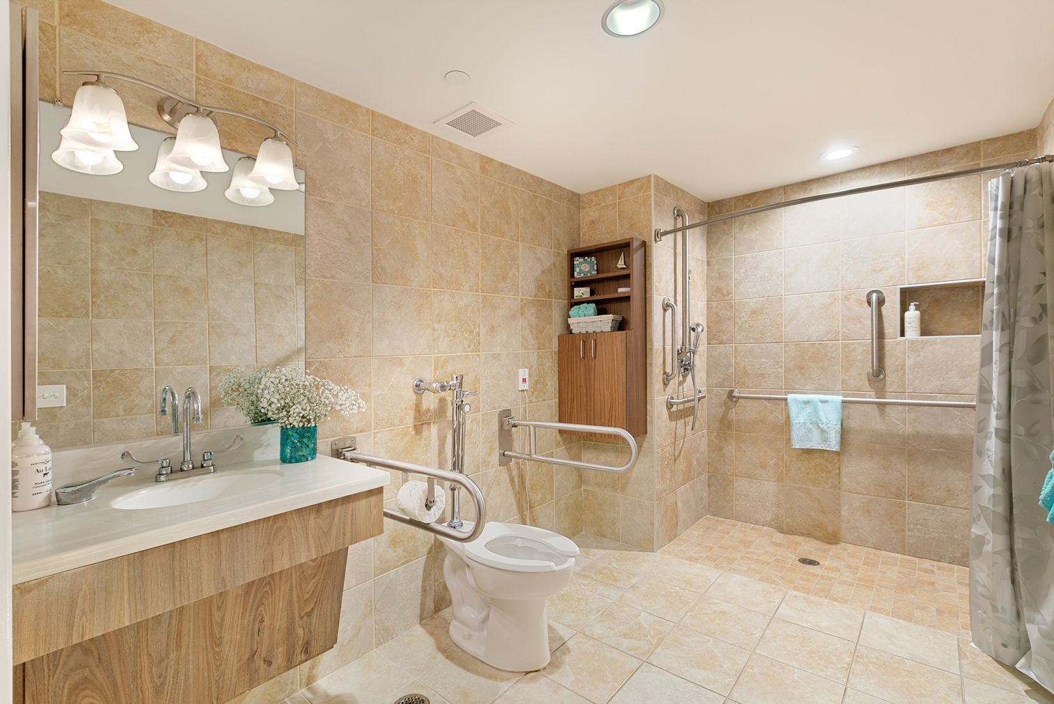 A bathroom with a toilet , sink , shower and mirror.
