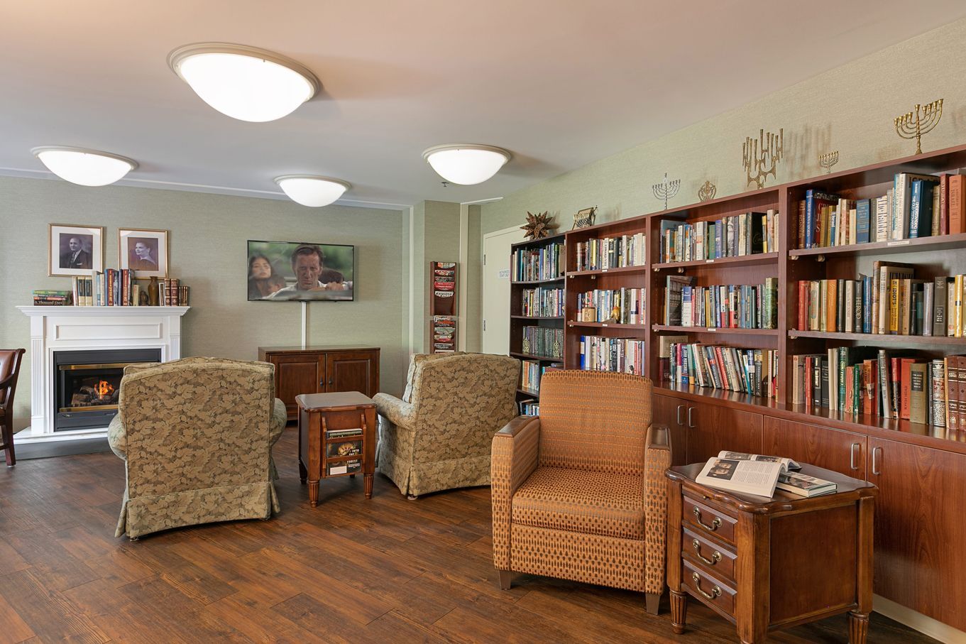 A living room filled with furniture and bookshelves.