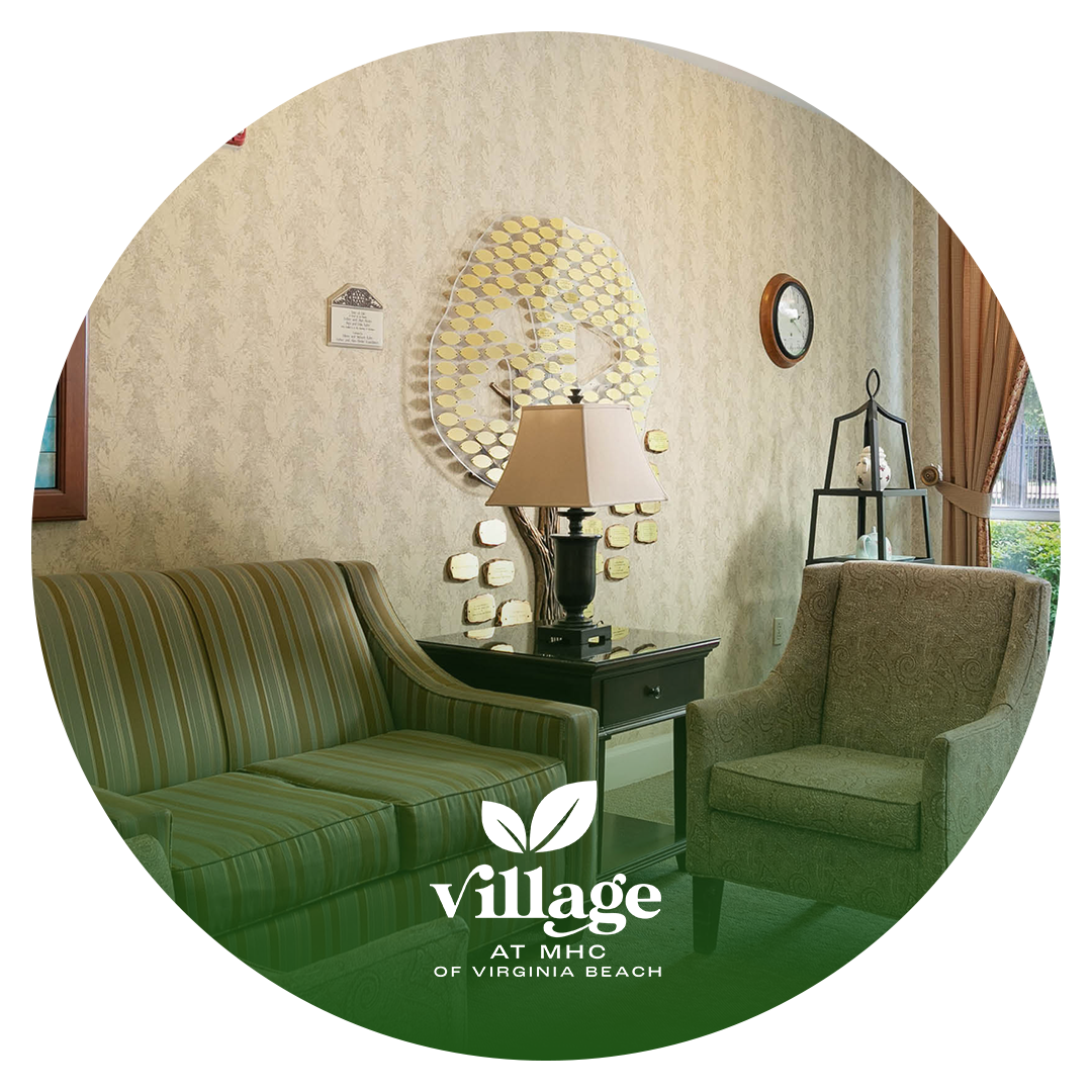 A living room with a couch and chairs and a lamp.