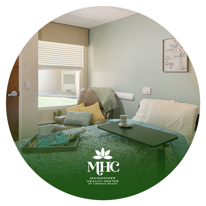 A hospital room with a bed , chair , table and window.