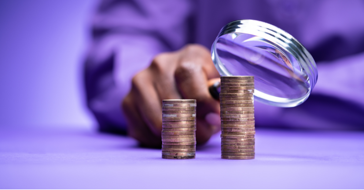 A magnifying glass taking a closer look at money