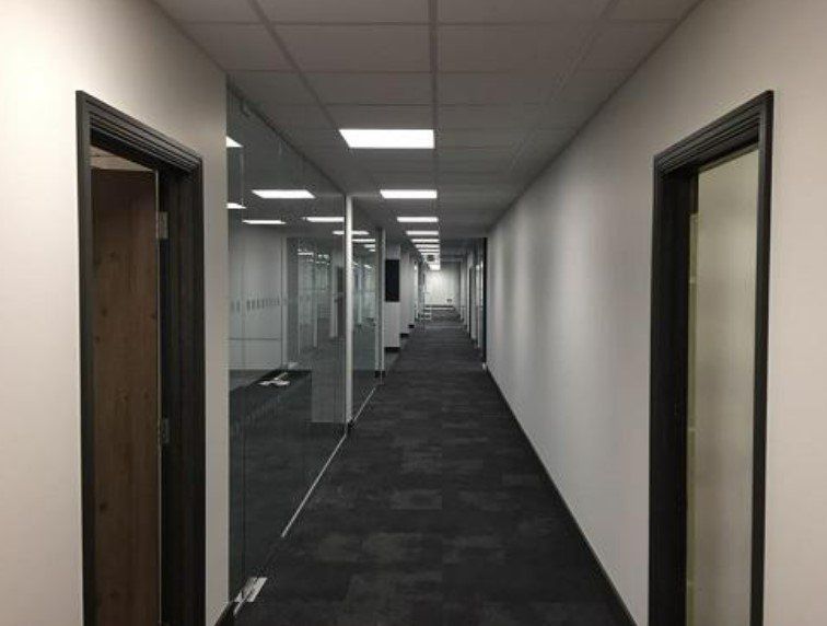 Picture of an office corridor that has recently been painted in white by painters and decorators Derby