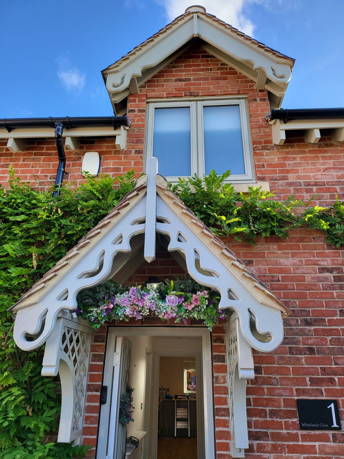 A picture of a porch, fascia and window painted in cream by painters and decorators Derby