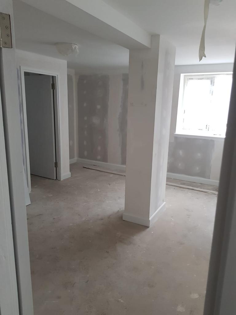 A picture of an apartment living room with new dry lining and painted  white by painters and decorators Derby