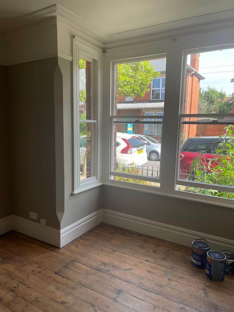 A picture of a living room bay window painted by painters and decorators London