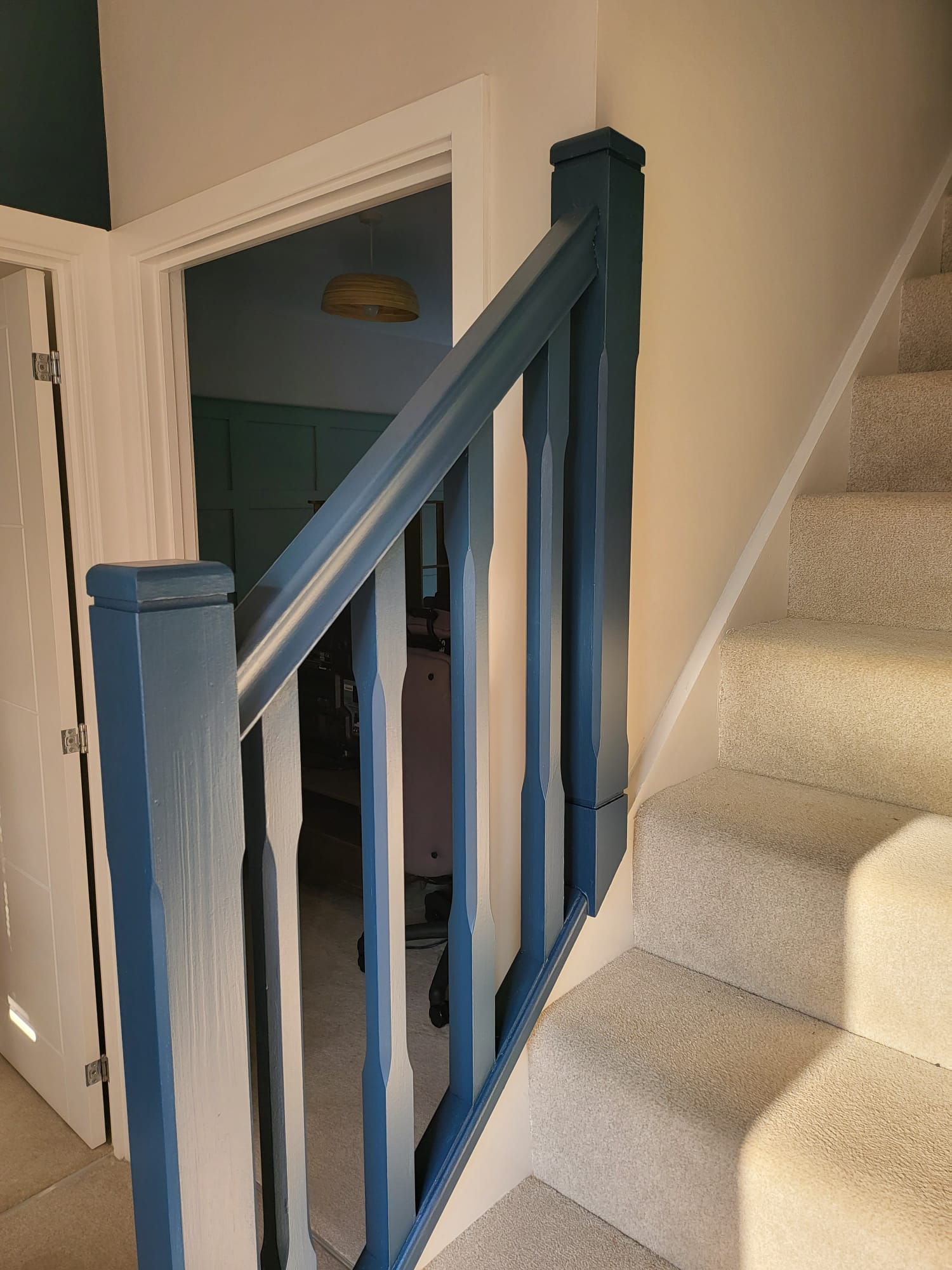 Picture of a bannister and railings painted in dark blue by painters and decorators Derby