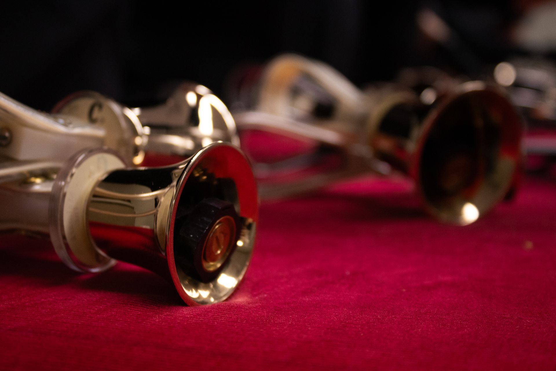 Brass handbells on red velvet.