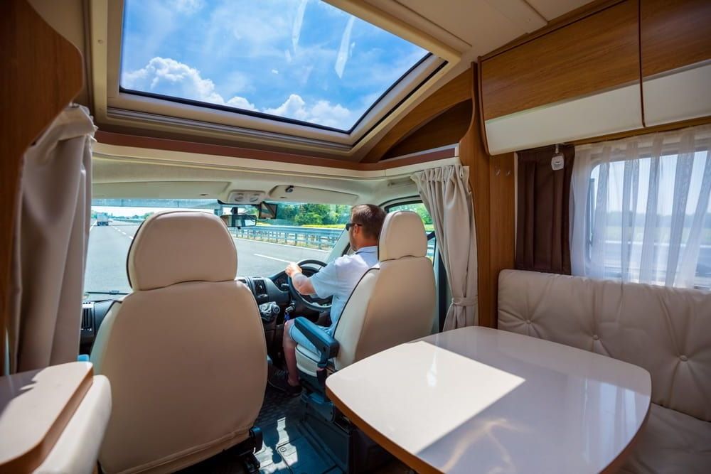 A Man Is Driving a Camper Van on A Highway — Allan Ross Mechanical Repairs in Charmhaven, NSW