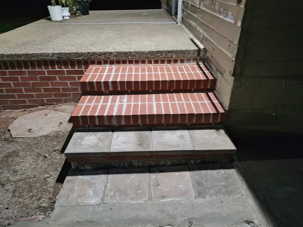 A set of brick steps leading up to a porch