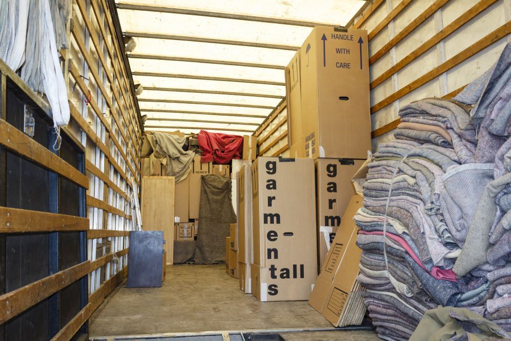 Packing Boxes And Packing Inside The Back Of A Large Removals Truck — LMB Carriers In Taree NSW