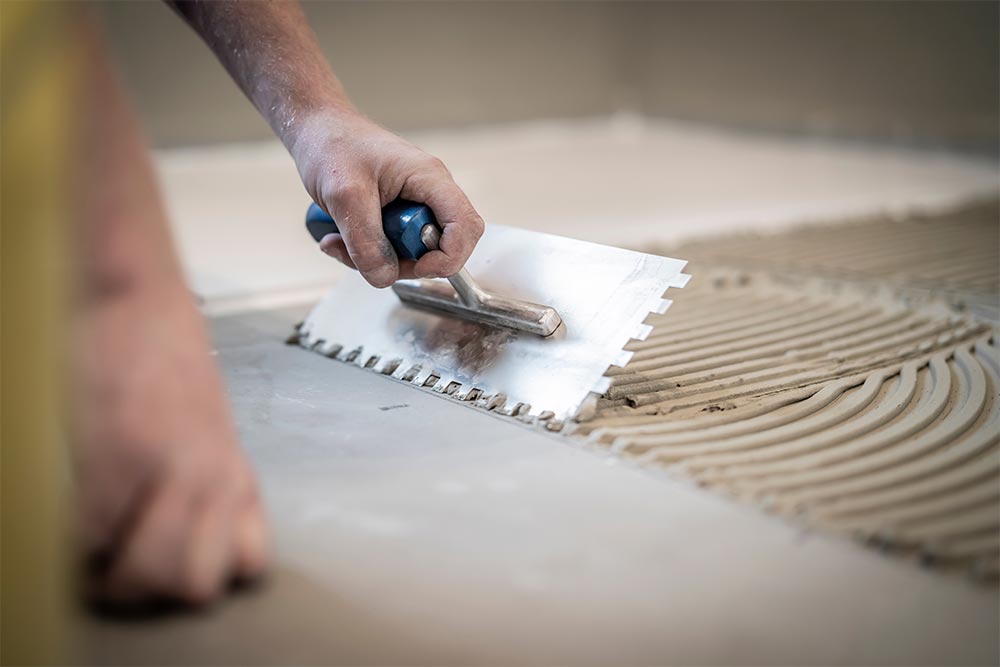 Tile Contractor Laying Tile Adhesive