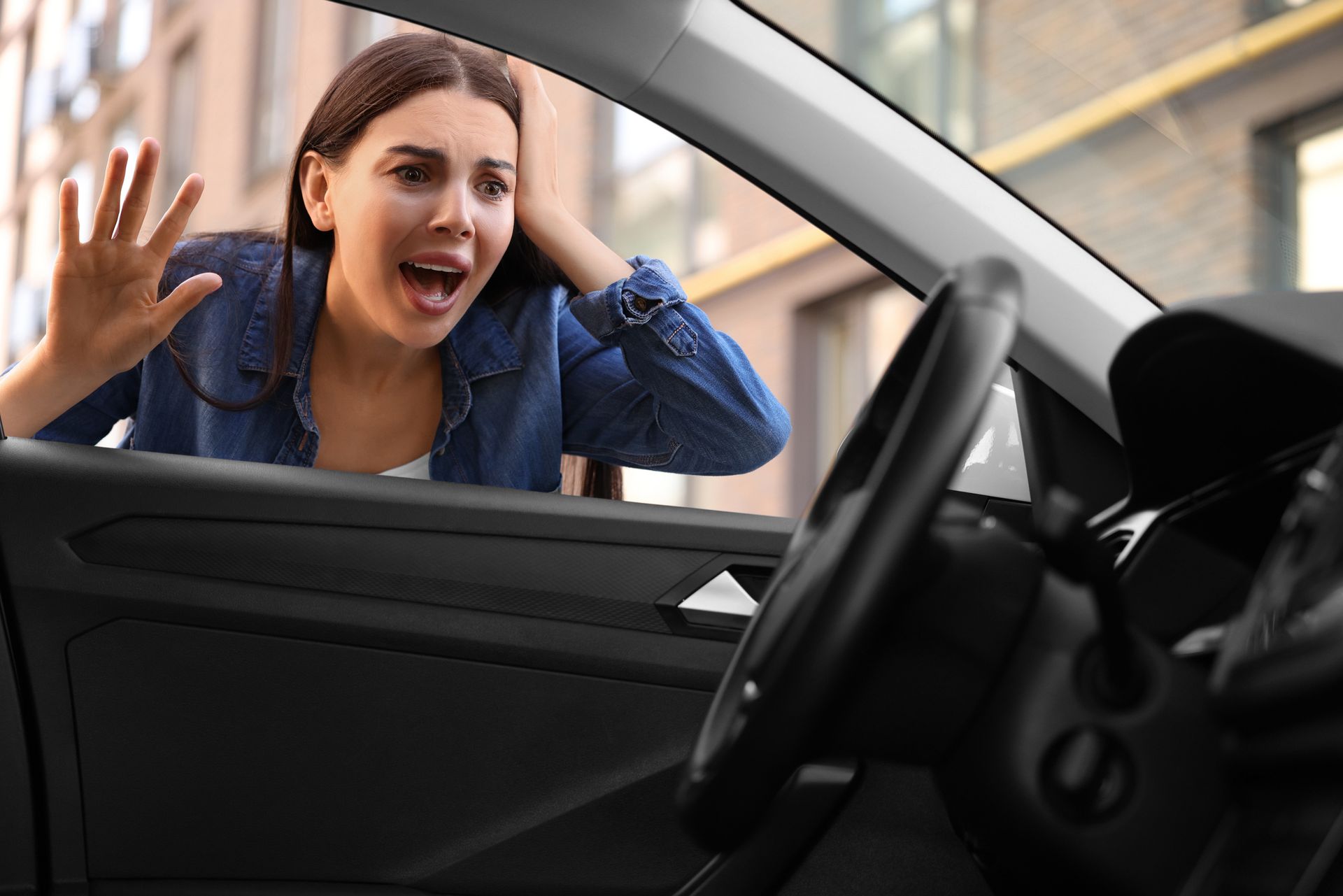 A woman is stressed due to being locked out of her car.