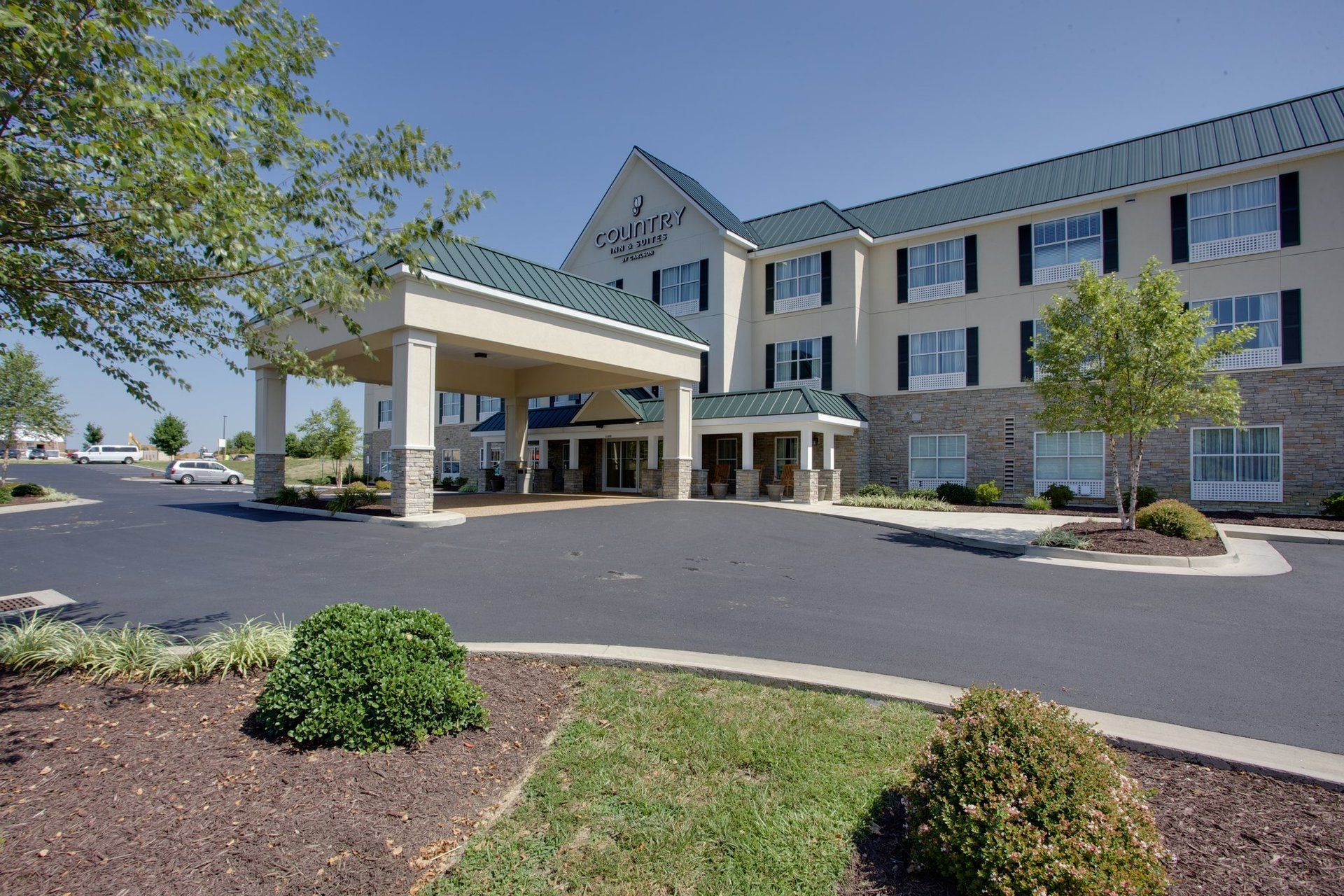 A large hotel with a lot of windows and a green roof