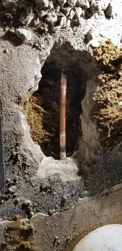 A pipe is coming out of a hole in the ground.