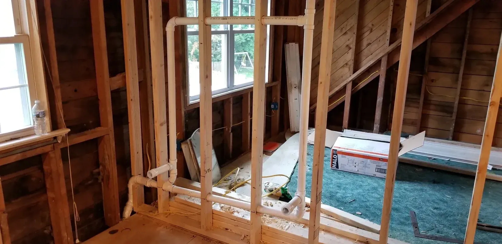 A room is being built with wooden beams and a window.