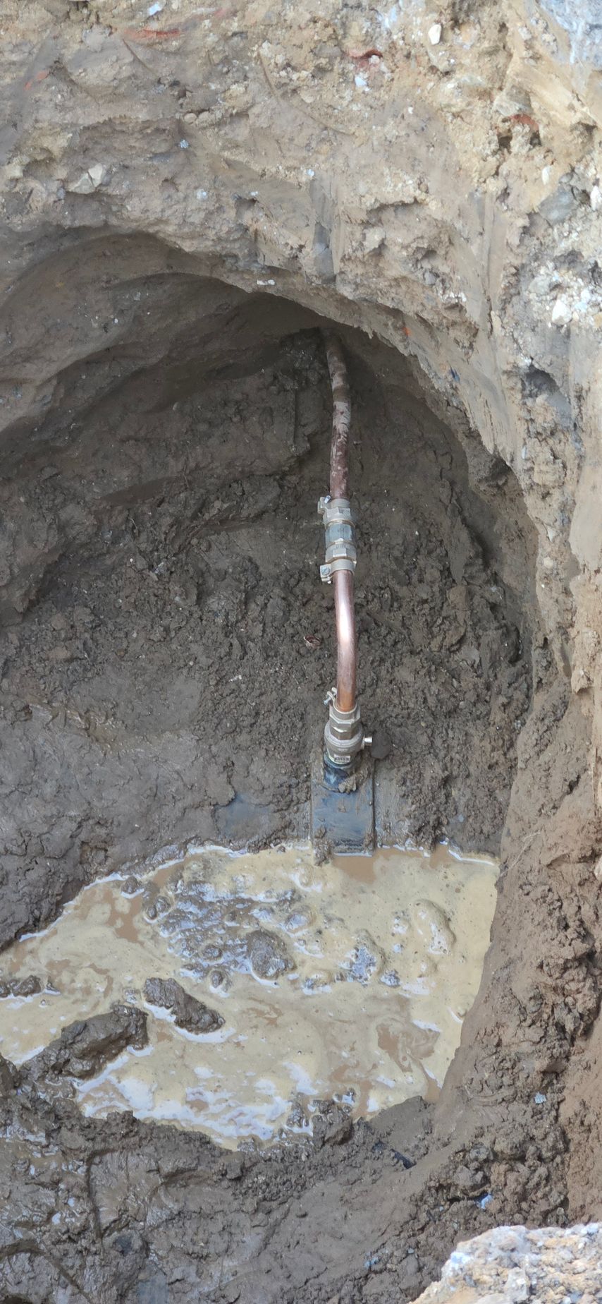 A room with a boiler and a water heater in it.