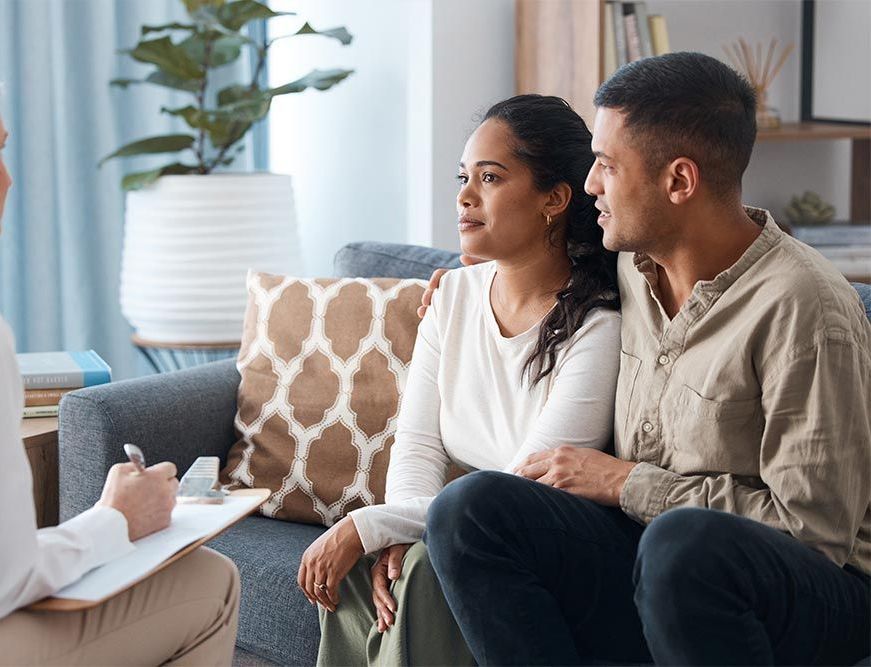 A man and a woman are chatting to therapist in couples therapy