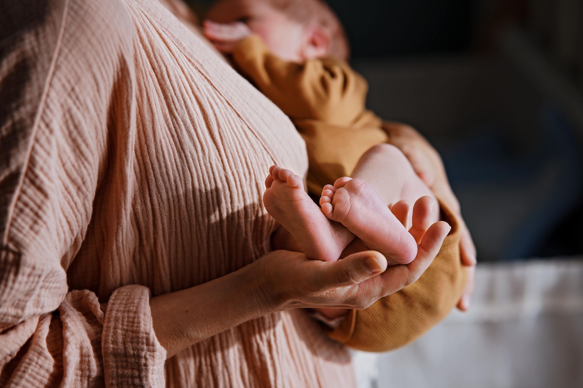 A rainbow flag is waving in the wind against a blue sky.