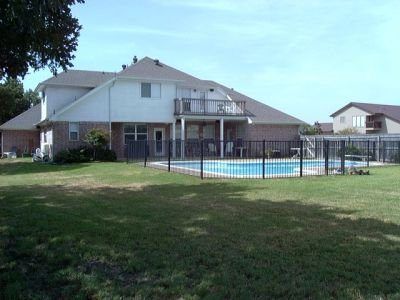 A large house with a swimming pool in the backyard