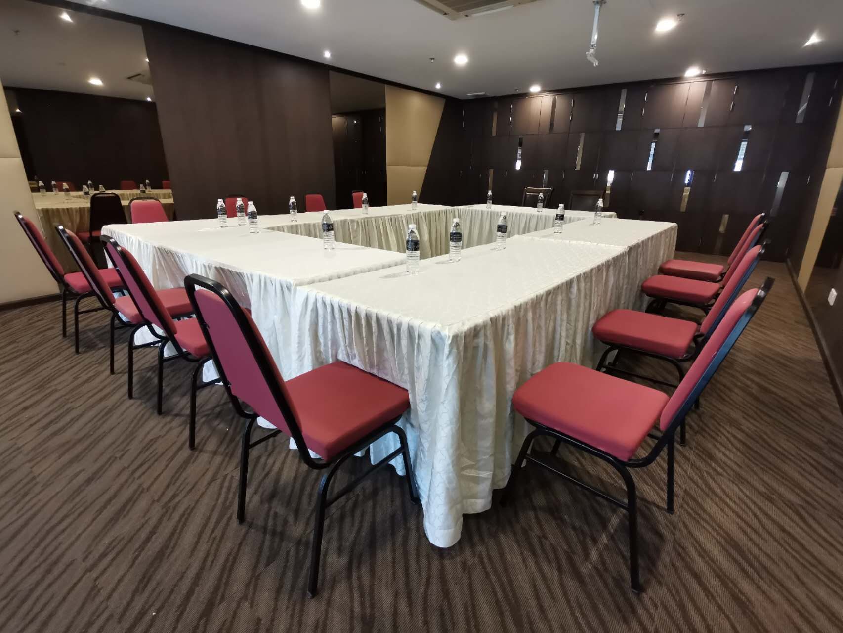 A conference room with tables and chairs set up for a meeting.