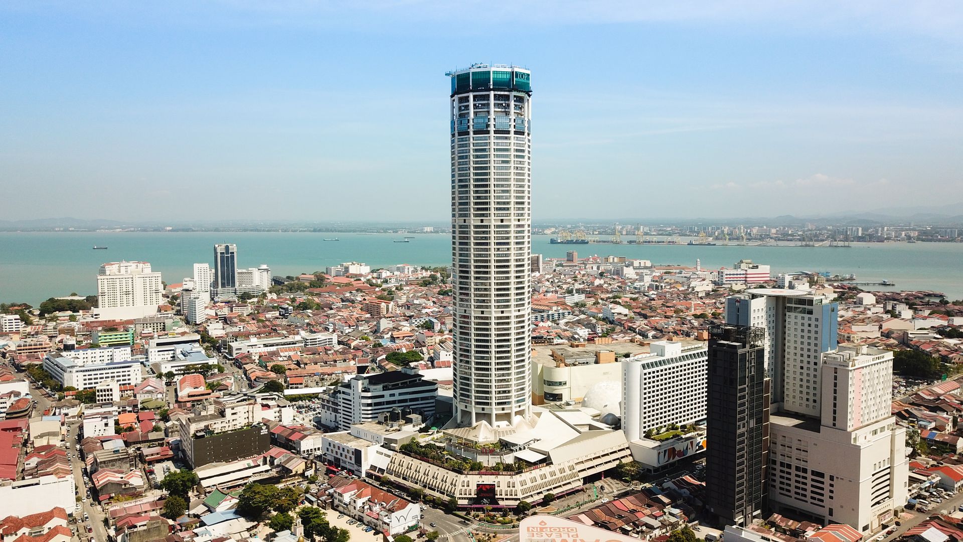 Image 39: An aerial view of a city with a tall building in the middle.