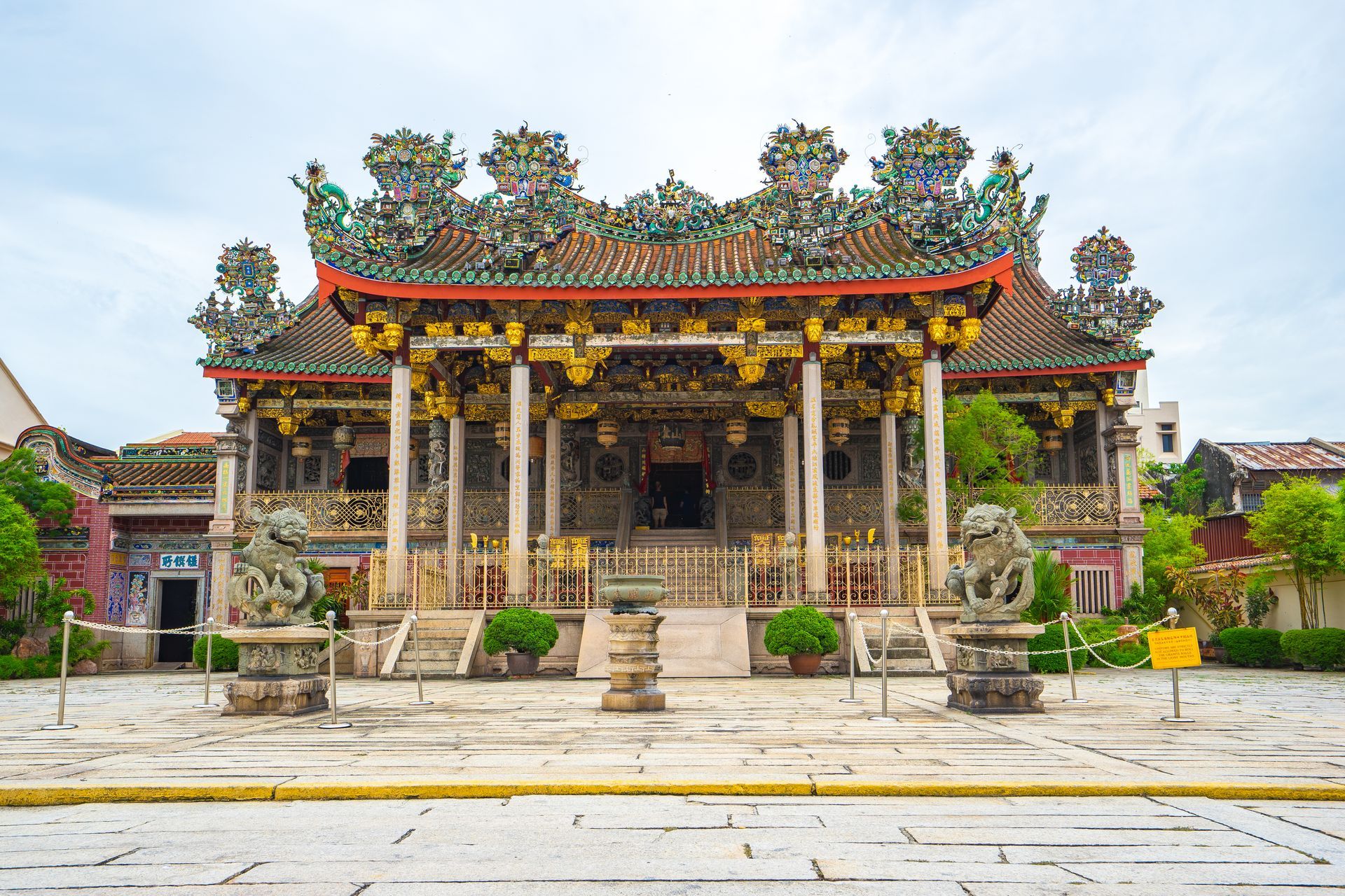 Image 41: A large chinese temple with a red roof and columns.