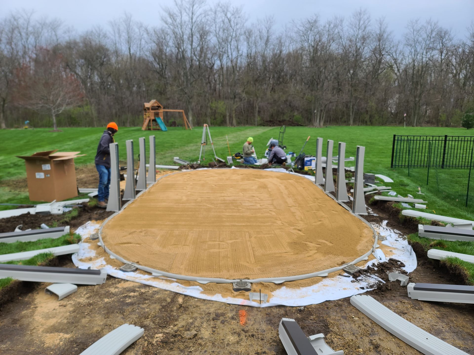 a group of people are working on a circular frame for an above ground pool