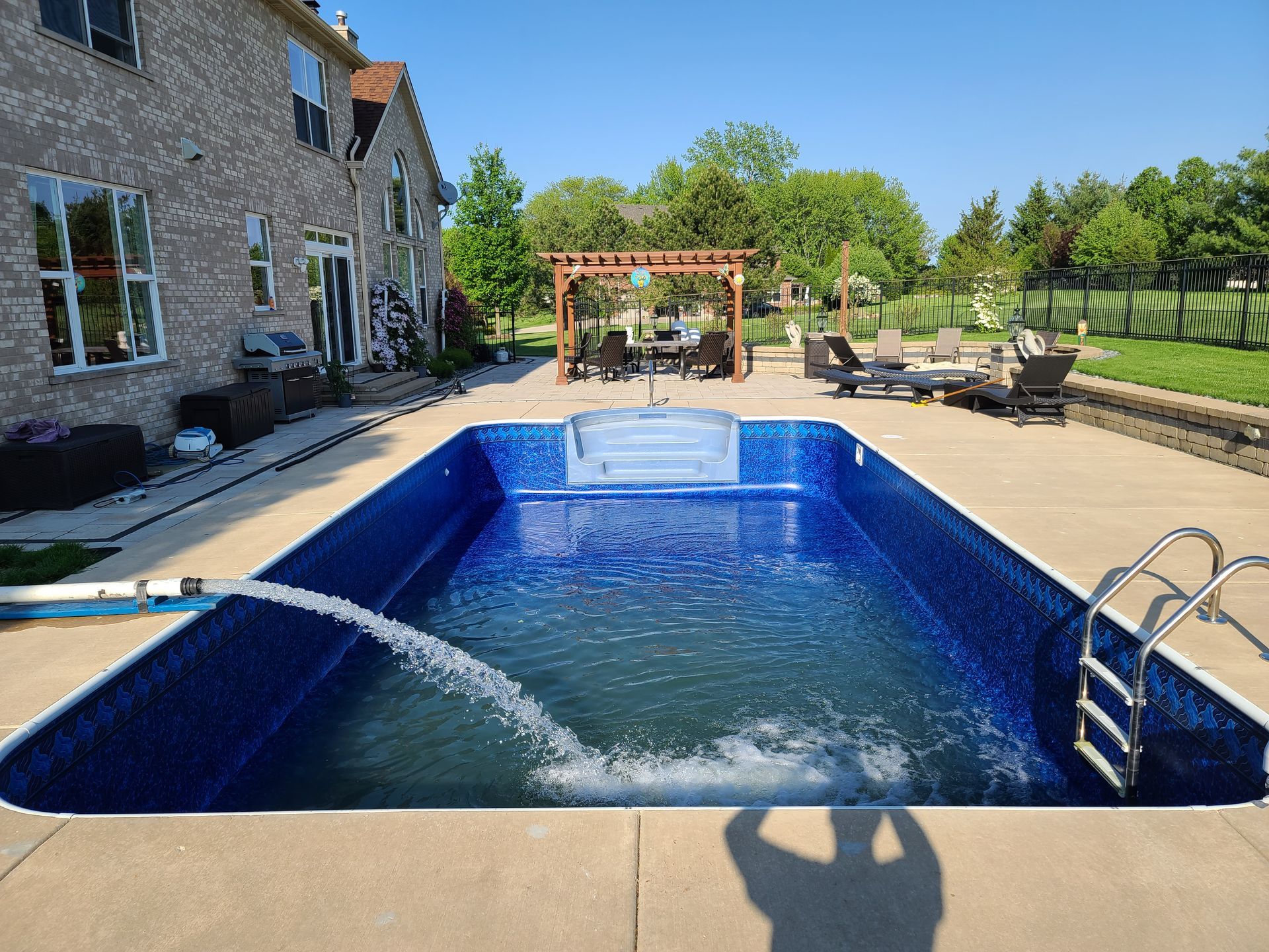 a large swimming pool is being filled with water .