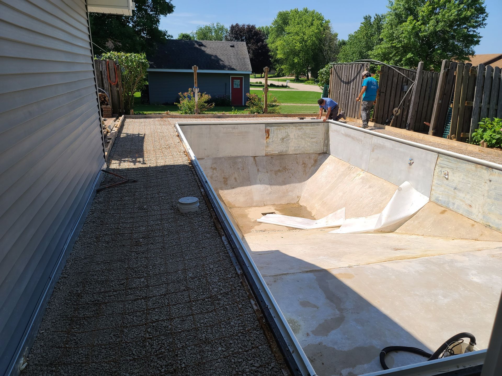 a swimming pool is being built in the backyard of a house