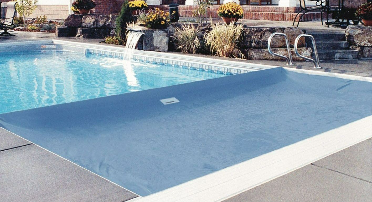Coverstar automatic pool cover. Blue cover with under coping track