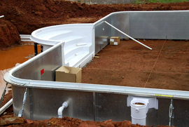 the sidewalls of a vinyl lined pool being built