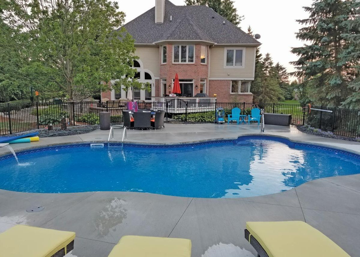 a large house with a large swimming pool in front of it