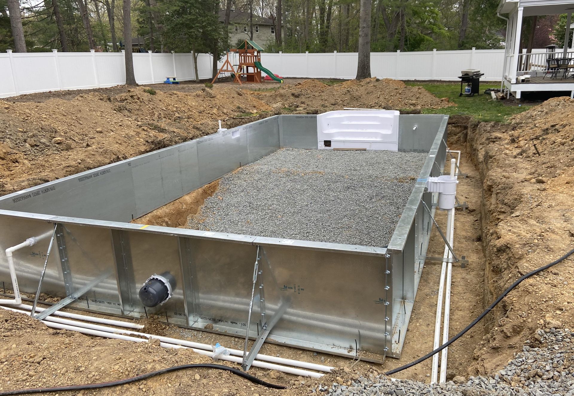 a metal swimming pool is being built in a backyard .