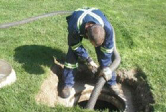A Man Cleaning a Septic — Crestview, FL — Zeb Watts Septic