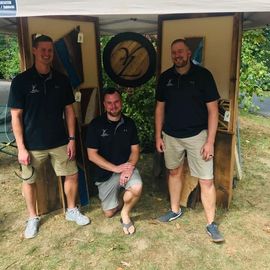 The YZ Lancaster team posing for a picture under a tent