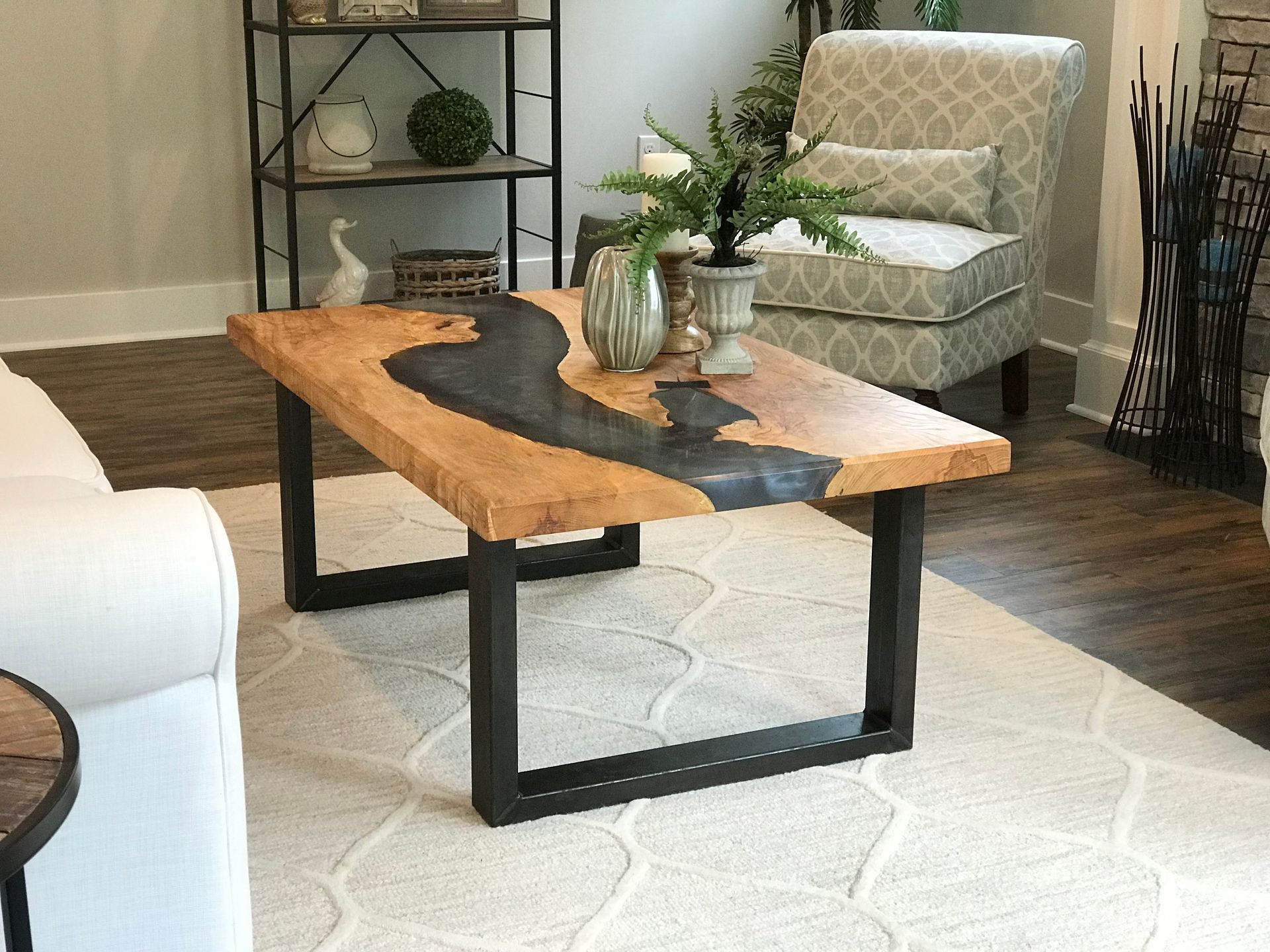A living room with a wooden coffee table and a chair
