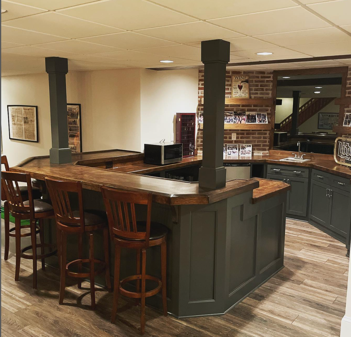 A kitchen with a bar and stools in it