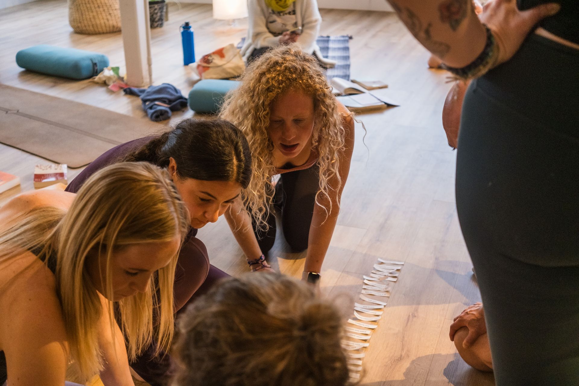 A group of people are playing a game on the floor.