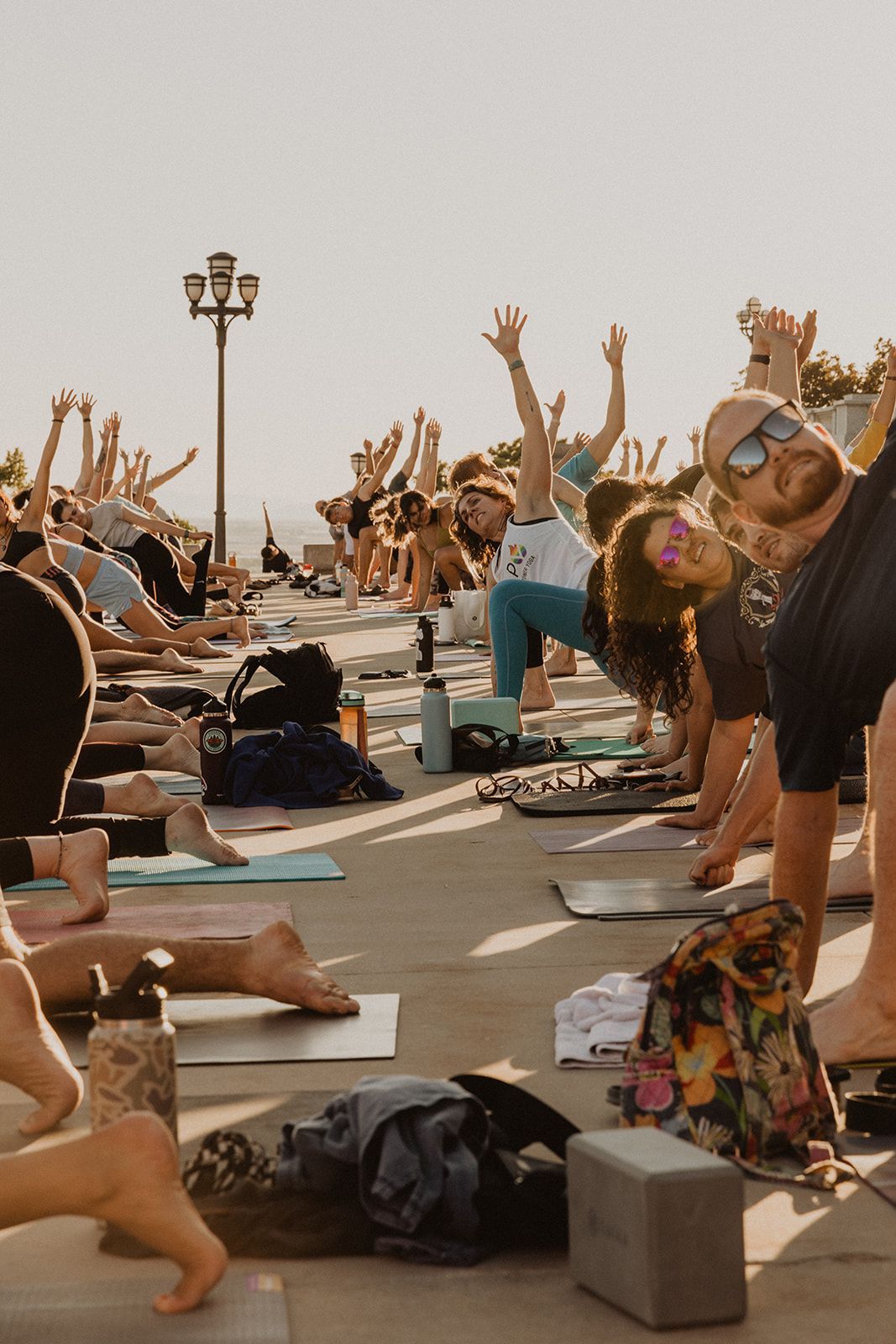 A group of people are doing yoga on the beach.