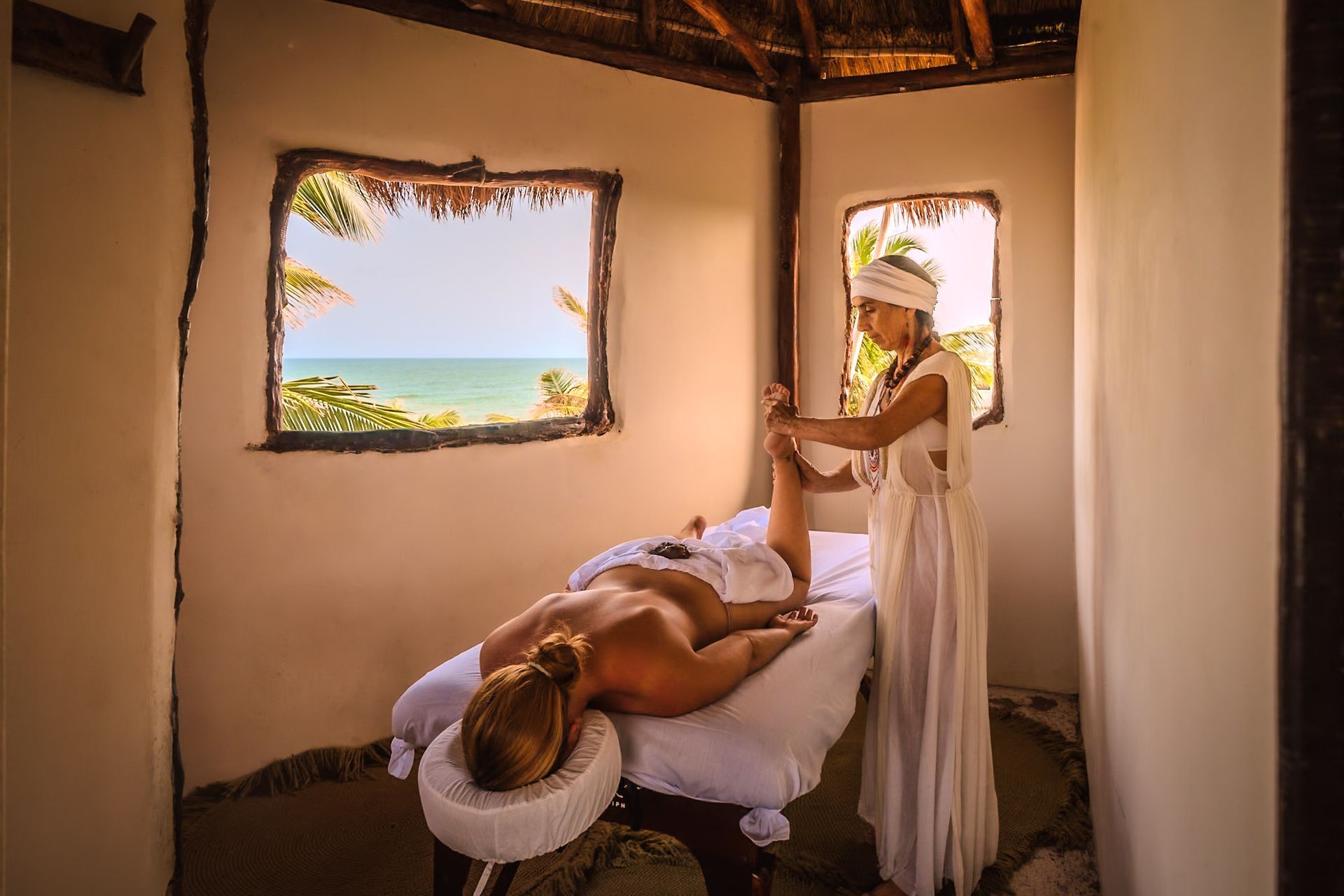 A woman is laying on a massage table getting a massage.