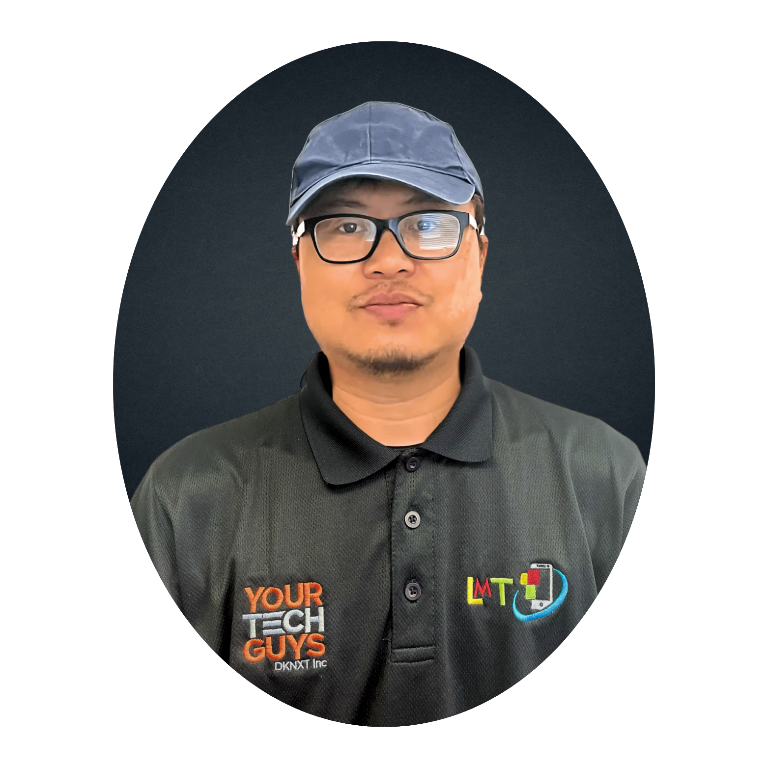 Man wearing glasses, a blue cap, and a black polo shirt with a company logo. He is centered in a dark oval frame.