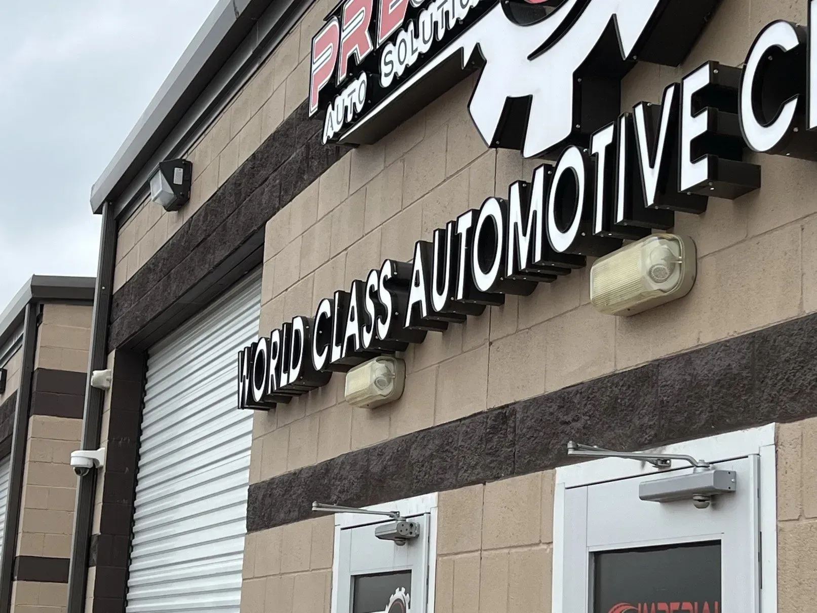 Exterior of an auto repair shop with a sign reading 