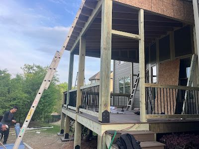 A wooden deck is being built on top of a house.