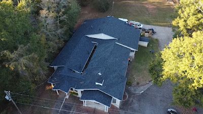 An aerial view of a large house surrounded by trees.