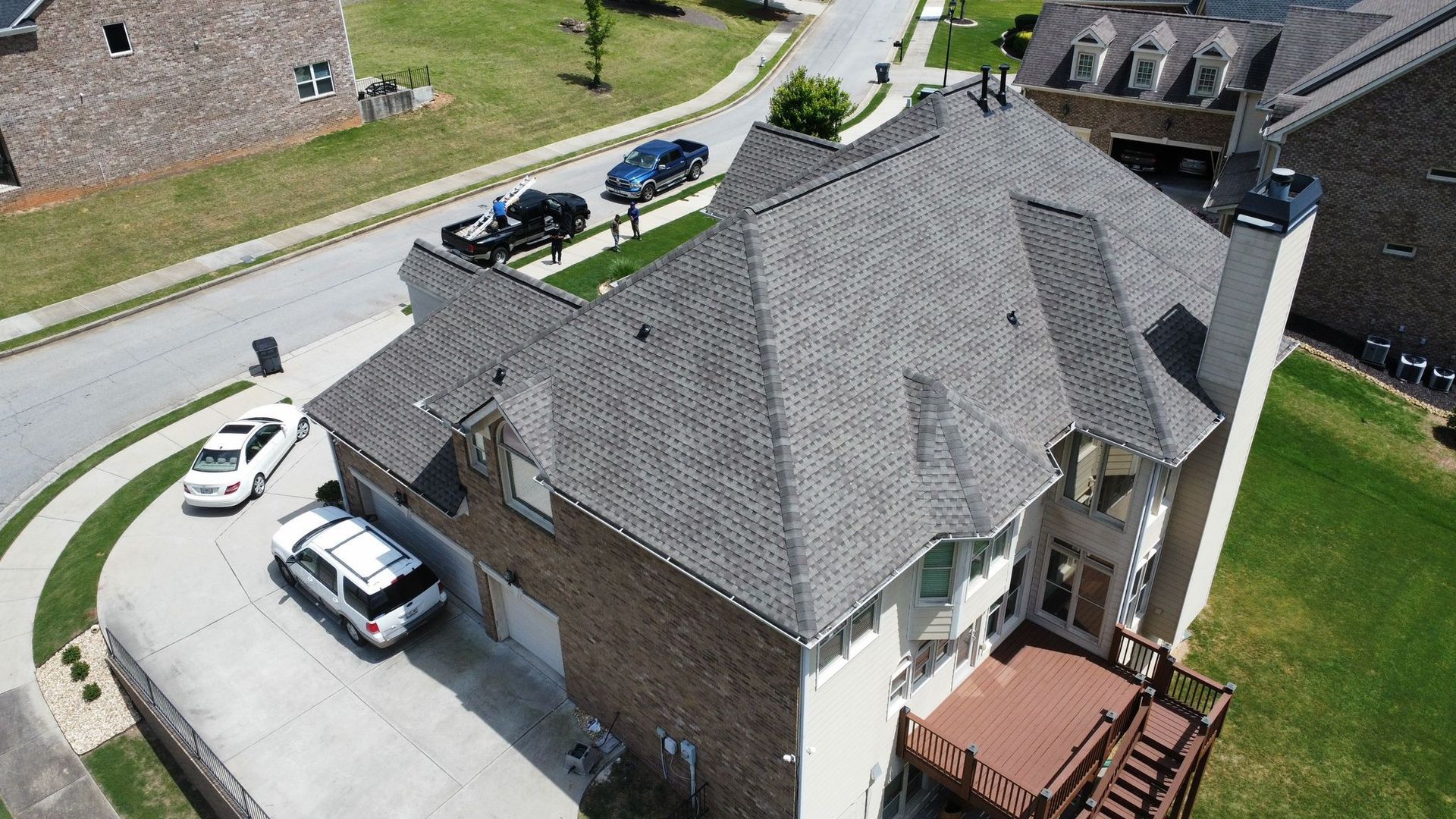 An aerial view of a house with a car parked in the driveway.