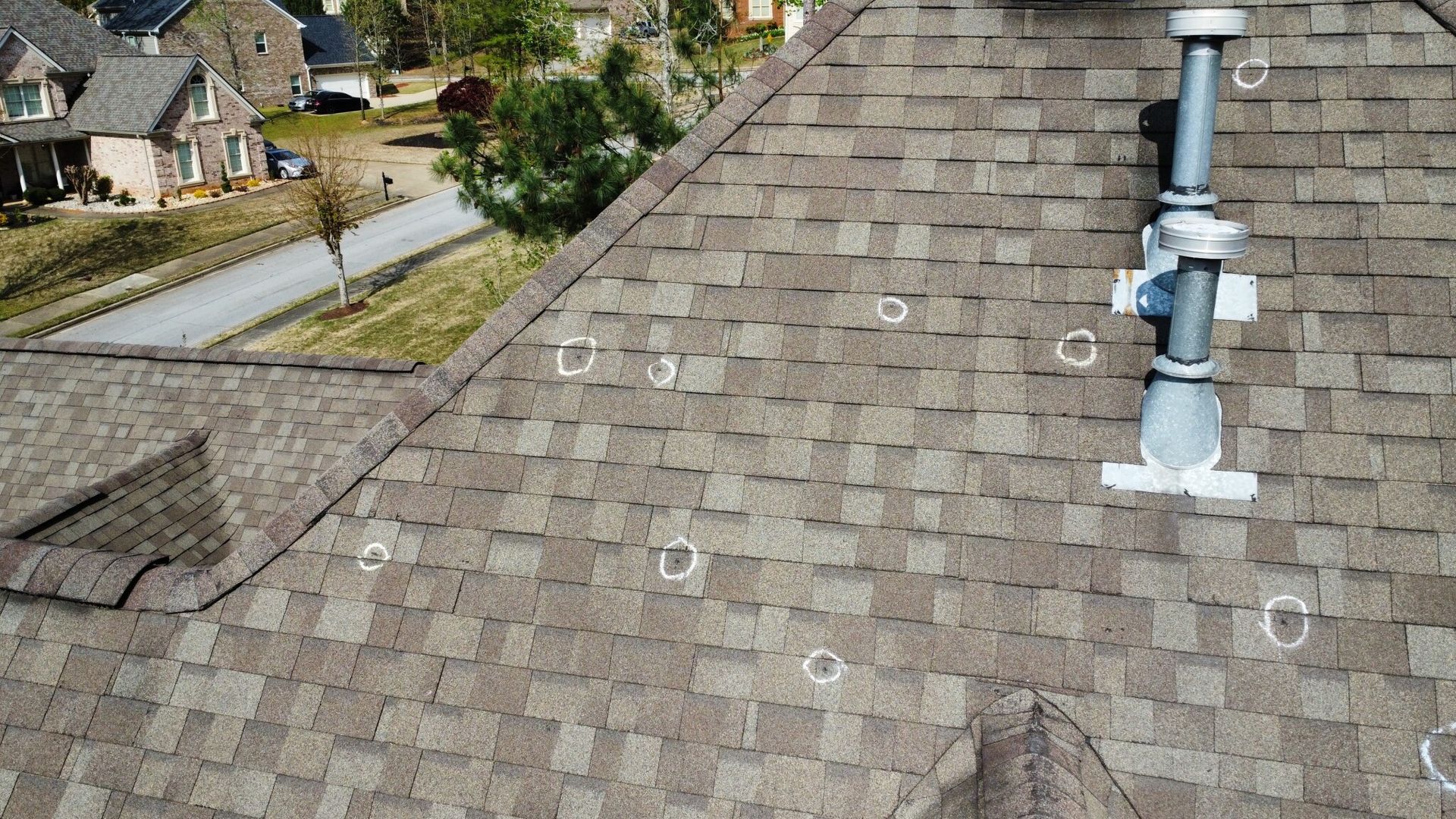A roof with holes in it and a chimney on top of it.