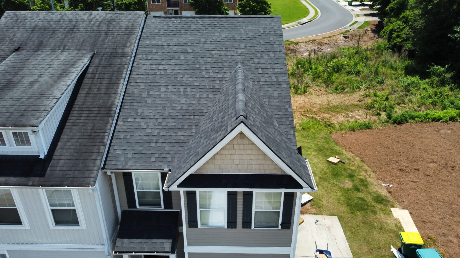 An aerial view of a house with a black roof.
