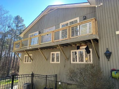 A large house with a balcony on the side of it.