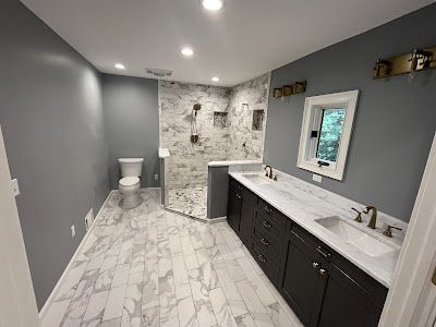 A bathroom with a toilet , sink , and shower.