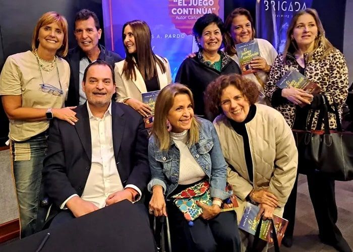 A group of people posing for a picture with one man in a wheelchair